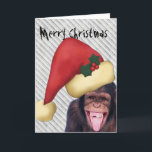 Cartão De Festividades Natal do papai noel do macaco<br><div class="desc">Cartão de Natal engraçado com um macaco de riso que veste um chapéu vermelho do papai noel. Está acima o texto customizável "Feliz Natal" na impressão muito má. Dentro de é um lugar para um texto mais customizável.</div>