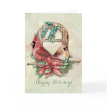 Pares dos cardeais do inverno com poinsétia