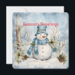 Cartão De Festividades Pinho de Neve Azul Pastel Cones Holly Winter Scene<br><div class="desc">Um azul pastel delicado domina a cena da floresta de inverno com um boneco de neve entre cones de pínus e Holly neste cartão de Natal que envia "Saudações da Estação". Personalizado no verso com seu nome,  é um verso adequado para os feriados.</div>