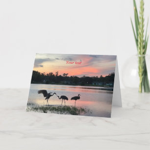 Cartão De Festividades Sandhill guia silhueta no pôr do sol no lago