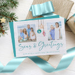 Cartão De Festividades Seas and Greetings Seashell Ornament Holiday Photo<br><div class="desc">Seas and Greetings Seashell Ornament Holiday Photo Christmas Cards featuring turquoise blue and sandy tan shell ornaments hanging from sailing jute rope with elegant typography. Add two of your photos and a personal message for a fun nautical holiday card. Please contact us at cedarandstring@gmail.com if you need assistance with the...</div>