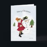 Cartão De Festividades Snowman e Little Girl Christmas Card<br><div class="desc">Menina num casaco vermelho brilhante colocando um chapéu preto num boné de neve.</div>