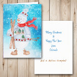 Cartão De Festividades Snowman Skier Christmas<br><div class="desc">A frente deste cartão de Natal tem uma imagem de aquarela de um bonitinho bonitinho de neve vestido com um suéter de inverno, chapéu e cachecol. Ele está segurando seus esquis e bastões de esqui, e é colocado sobre uma neve brilhante e azul de abstrato e fundo estelar. Dentro da...</div>