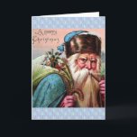 Cartão De Festividades Tubulação de fumo azul de Papai Noel da veste -<br><div class="desc">Feliz Natal. Imagem do Xmas do vintage de um cartão antigo CA 1910. O papai noel tem em uma veste azul, em um chapéu azul com guarnição marrom da pele, em uma barba muito longa, e está fumando uma tubulação. Tem um saco dos brinquedos lançados sobre seu ombro. Papai noel...</div>