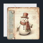 Cartão De Festividades Vintage Snowman Christmas<br><div class="desc">Celebre a estação com este cartão de feriado animador, com um bonitão alegre de neve em um chapéu vermelho e cachecol, segurando galhos de pinheiro como buquês festivos. Colocada contra um pano de fundo de flocos de neve, notas musicais e texturas antigas, esta design evoca memórias confortáveis de inverno e...</div>