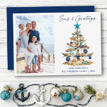 Cartão De Festividades Watercolor Tree Seas and Greetings Photo Beach<br><div class="desc">Modern Minimalist Elegance Calligraphy Ink Pen Handwritten Script Seas & Greetings Coastal Holiday Card includes a Watercolor Christmas Tree make of beach ocean driftwood,  seashells,  sand dollars,  nautical anchor ornament and topped with a starfish. Navy Blue Text. Photo Front.</div>