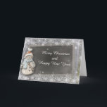 Cartão de Natal do ano novo do quadro do boneco de<br><div class="desc">O cartão encantador do Natal caracteriza um fundo da prata do floco de neve com um boneco de neve ao lado de um quadro. O texto dianteiro lê: Feliz Natal e feliz ano novo. O cartão interno lê: Está aqui um desejo para a paz e a felicidade no Natal e...</div>