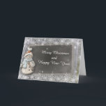 Cartão de Natal do ano novo do quadro do boneco de<br><div class="desc">O cartão encantador do Natal caracteriza um fundo da prata do floco de neve com um boneco de neve ao lado de um quadro. O texto dianteiro lê: Feliz Natal e feliz ano novo. O cartão interno lê: Está aqui um desejo para a paz e a felicidade no Natal e...</div>