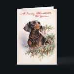 Cartão de Natal do Dachshund do vintage<br><div class="desc">Imagem do vintage de um dachshund bonito com um ramo do pinho em sua boca e nas palavras "Feliz Natal a você" acima dele.</div>