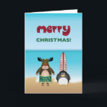Cartão de Natal do tema da praia<br><div class="desc">Cartão de cartões de natal do divertimento para algum amante da praia! Uma rena do surfista e seu amigo do pinguim estão obtendo prontos para travar algumas ondas em uma praia tropical.</div>