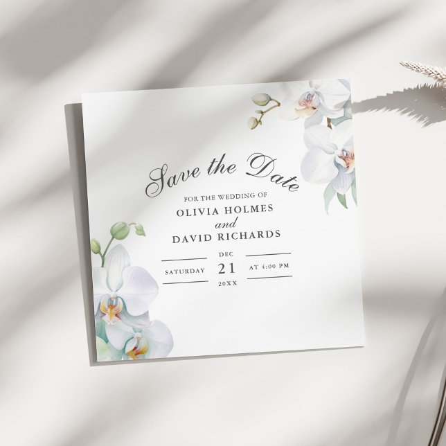 Cartão de Salvar a Data de Orquídea Branca Elegant (Modern Elegant White Orchid Save the Date Card on a sunny white table.)
