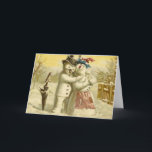 Cartão do boneco de neve e de Natal do snowwoman<br><div class="desc">Uma imagem do vintage de um boneco de neve e um snowlady,  um pisco de peito vermelho sentam-se no punho de um guarda-chuva. O casal está obviamente no amor</div>