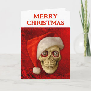Cartão Feliz Natal. Caveira usando chapéu de Papai Noel