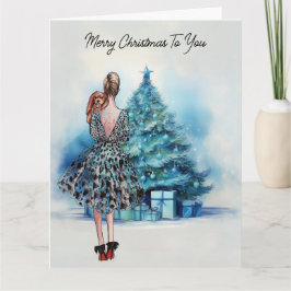 Cartão Feliz Natal, mulher e árvore de Natal azul