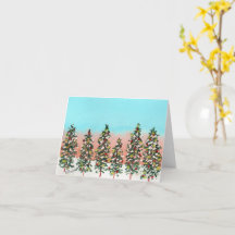 Fila pré-amanhecer de árvores de Natal coloridas