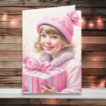Cartão Garota Bonita de Rosa no Retro Natal<br><div class="desc">Cartão de Natal bonito. Adorável menina vintage no boné de inverno segurando uma caixa de presente retrô em rosa.</div>