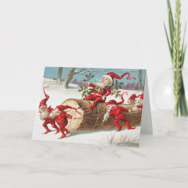 Cartão Gnomes dragging a cut tree trunk through the snow