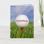 Cartão Golf Ball On Tee for Grandson<br><div class="desc">Feche a bola de golfe no chá vermelho na grama verde para o aniversário do neto. O texto na bola pode ser editado.</div>