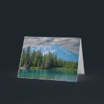 Cartão Lake and Mountain in Banff, Canada<br><div class="desc">Photo that includes the turquoise-green water that typically is in lakes around Banff in Alberta,  Canada. There is a dense forest of pine and spruce trees along the lake shoreline. A large mountain is in the background under a blue sky with white clouds.</div>