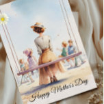 Cartão Nostalgic Watercolor  Mother's Day<br><div class="desc">Honor the quiet strength and tenderness of motherhood with this serene nostalgic watercolor Mother’s Day card. The illustration captures a peaceful seaside moment—a mother sitting with her children, watching the world unfold. Soft light, gentle tones, and delicate brushstrokes create a calming, heartfelt scene that reflects the steady love moms offer...</div>