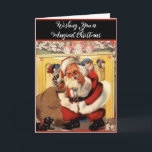 Cartão Papais noeis na Lareira com o Retro da Vintage às<br><div class="desc">Papai Noel, em seu terno de pele vermelho e branco, em frente a uma manta de lareira coberta com decorações de Natal e um filhote preto bonito e um filhote branco aos seus pés. Ele está descendo a chaminé ou deixando o dedo de lado o nariz para voltar para cima?...</div>