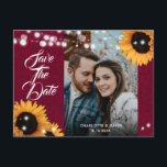 Cartão Postal De Anúncio Sunflower Burgundy Wedding Photo Save The Date<br><div class="desc">Rustic burgundy and sunflower wedding photo save the date postcard featuring sunflowers and string lights on a burlap background. Ideal card design for inviting your guest to your burgundy rustic country,  garden or barn wedding party inspired by sunflower flowers.</div>