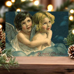 Cartão Postal De Festividades Ângels Um Feliz Natal<br><div class="desc">natais vintages Belos,  Angel Children. Saudações de "Feliz Natal" escritas no canto inferior direito. Este design apresenta duas belas crianças com asas de anjo sentadas nas nuvens num abraço amoroso.</div>