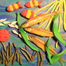Escultura em argila de peixes, pintada sutilmente