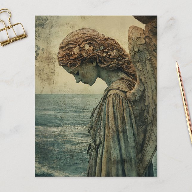 Cartão Postal Estátua de Anjo com Pátina (Angel statue covered in patina and distressed on a postcard that is laid on a marble flat surface.)