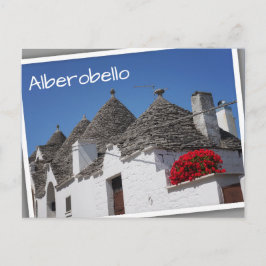 Cartão Postal Flores de gerânio e casas de trulli em Alberobello