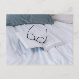 Cartão Postal reading in bed minimal white sheets literary