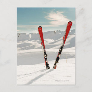 Cartão Postal Red pair of ski standing in snow