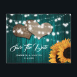Cartão Postal Sunflower Teal Wood Wedding Save The Date<br><div class="desc">Teal and sunflower wedding save the date postcard featuring sunflowers,  string lights and burlap hearts against a rustic wood background.</div>