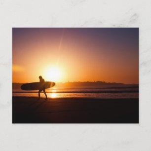 Cartão Postal Surfista de Carregando na praia no Sunset