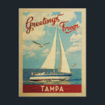 Cartão Postal Tampa Sailboat Viagens vintage Florida<br><div class="desc">Esta viagens vintage náutica design de Saudações de Tampa Flórida apresenta um barco navegando na água com gaivotas e um céu azul cheio de lindas nuvens brancas puffy.</div>