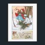 Cartão Postal Vintage Children in Snow com a Holly de Natal<br><div class="desc">Duas doces crianças da era vitoriana,  uma com pelo branco e outra com capa vermelha e espada azul,  juntando o Natal numa floresta coberta de neve. A parte traseira apresenta gráficos complementares e campos de texto editáveis.</div>