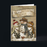 Cartão primitivo do Natal do boneco de neve<br><div class="desc">O cartão primitivo do Natal com um boneco de neve que reliaxing no céu nocturno com a neve lasca-se caindo.</div>