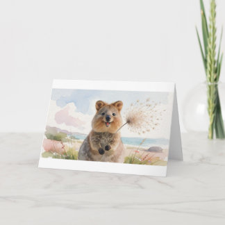 Cartão Quokka soprando uma cabeça de semente fofa na bris