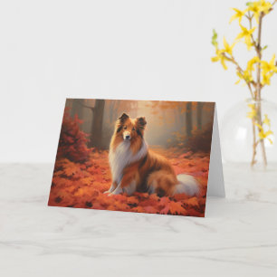 Cartão Shetland Sheepdog nas Folhas de Outono Caídas Insp