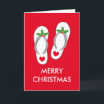 Cartão tropical do Natal com chinelos<br><div class="desc">Cartão tropical do Natal com chinelos. O cartão vermelho bonito do feriado com costume tempera cumprimentos e flip-flops. Deslizadores da praia com as folhas verdes do azevinho e as bagas vermelhas. As sandálias engraçadas do coração projetam para a casa ou o escritório da empresa no clima morno. Igualmente agradável como...</div>