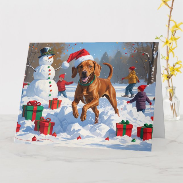Cartão Vizsla Correndo na Neve com Chapéu de Natal (Flor Amarela)