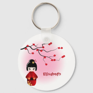 Chaveiro A boneca japonesa do kokeshi em sakura floresce