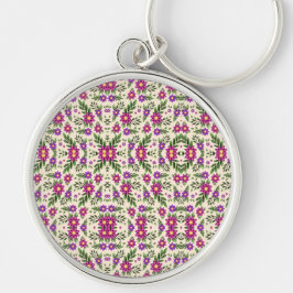 Chaveiro A round keychain features a detailed floral 