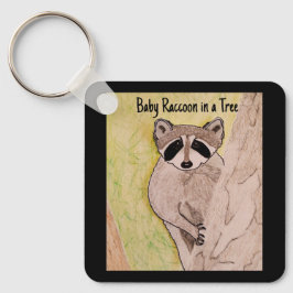 Chaveiro Baby Raccoon em uma árvore