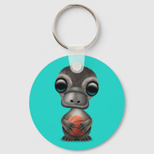 Chaveiro Bebê bonito Platypus que joga com basquetebol