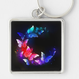 Chaveiro Borboletas Neon Night brilhantes sobre fundo preto