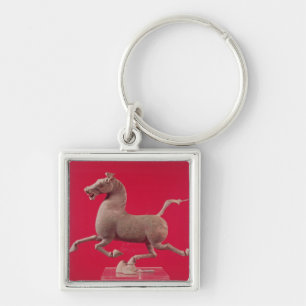 Chaveiro Cavalo de galope com o um casco que descansa em a
