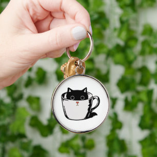 Chaveiro Gato preto com nariz vermelho escondido em um copo