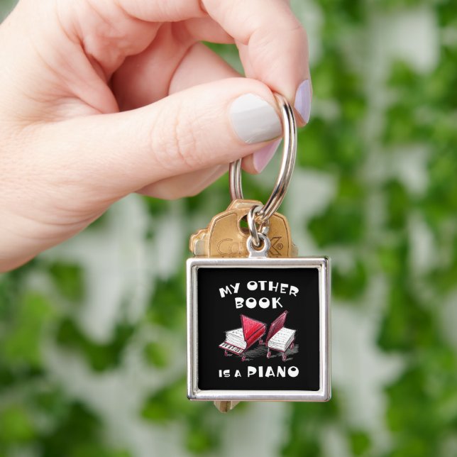 Chaveiro Grandes Ideias Sobre Rodas - Livro 🎵 Piano (Mão)