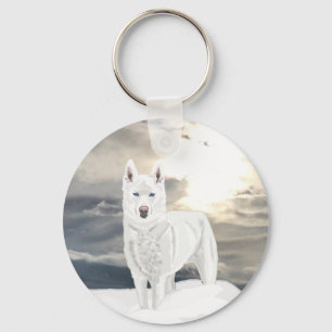 Chaveiro Husky branco de olhos azuis, na neve